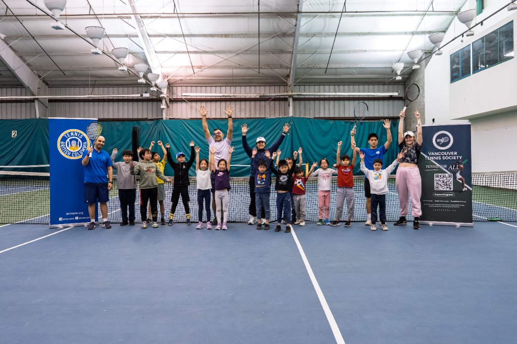 Group photo of kids and coaches on court