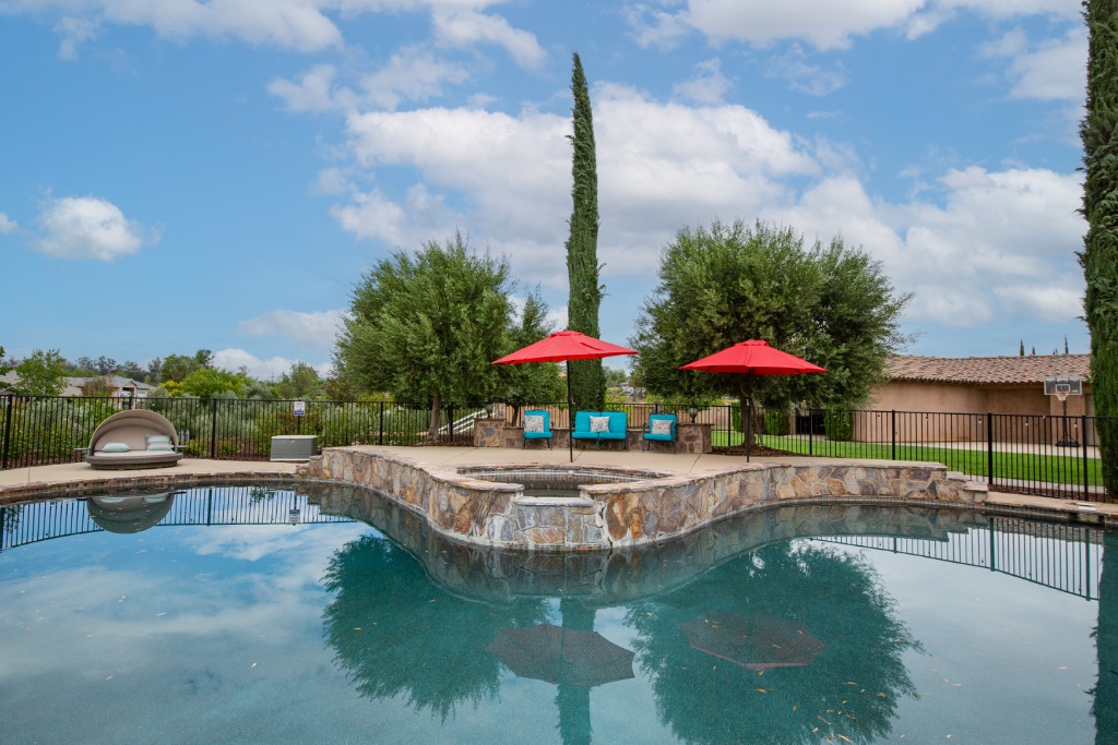 Resort-style pool with spa and seating area