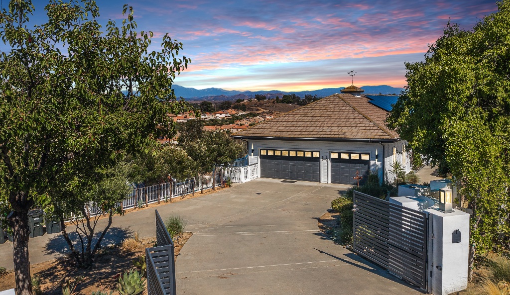 Luxury home driveway at sunset with mountain views
