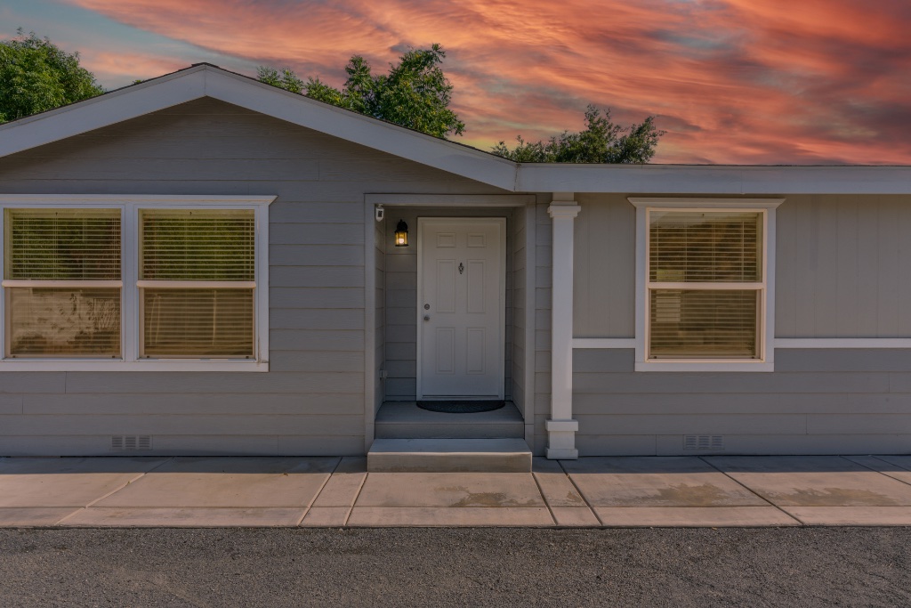Home exterior at sunset with dramatic sky