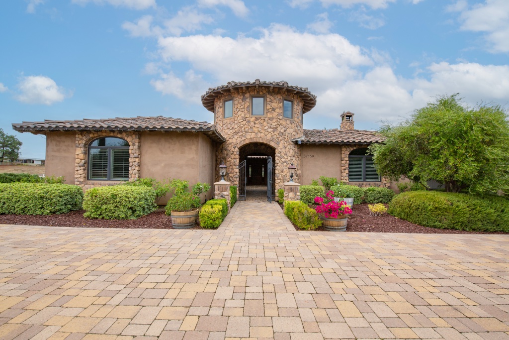 Elegant stone home exterior with manicured landscaping