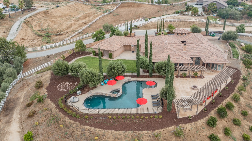 Aerial view of estate with pool and cypress trees