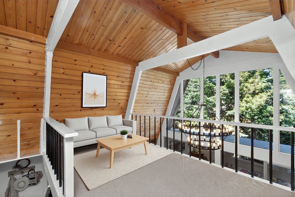 Loft sitting area with wood beams and large windows