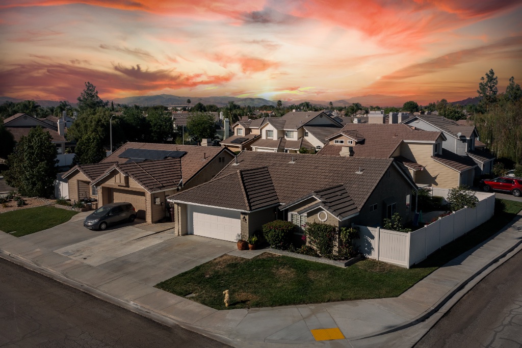 Home aerial view at sunset with mountains