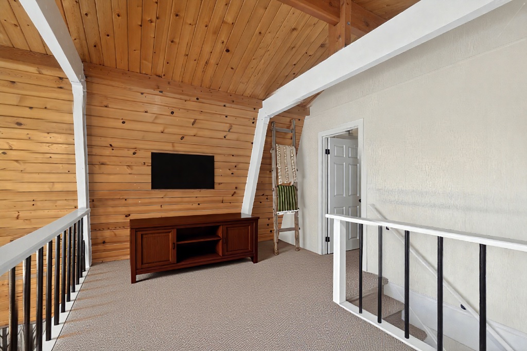 Loft TV room with wood ceiling and rustic charm