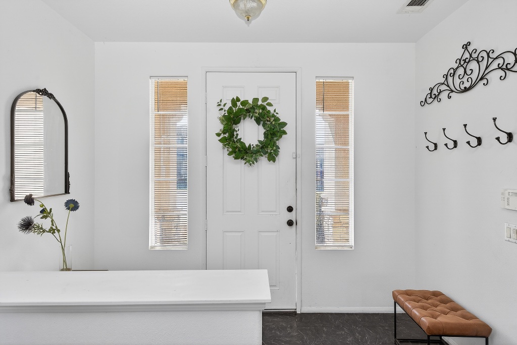 Entry foyer with wreath on white door