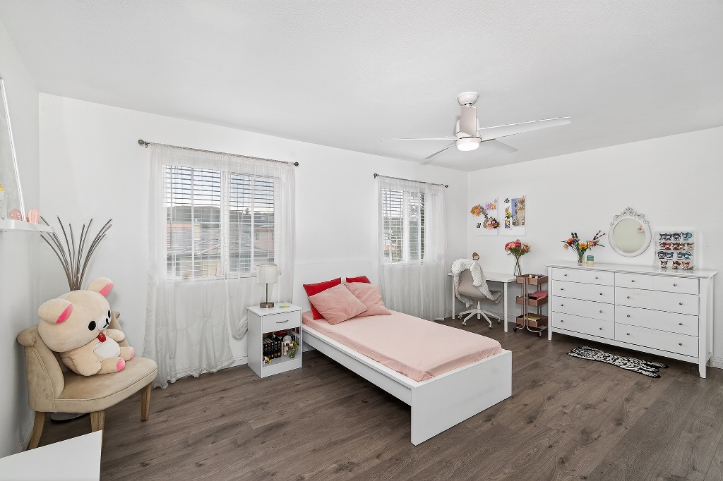 Girls bedroom with pink bedding and white furniture