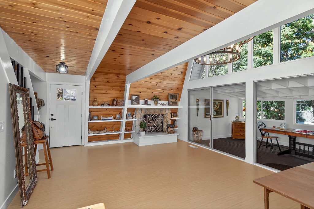 Loft living area with wood beams and large windows