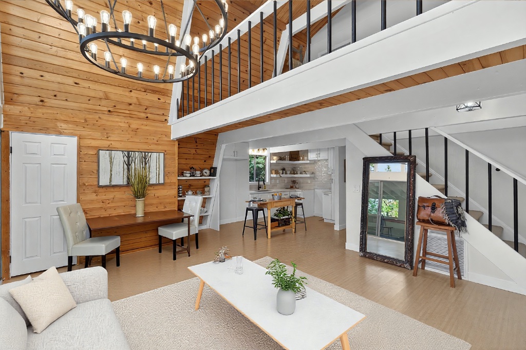 Grand living room with chandelier and loft above