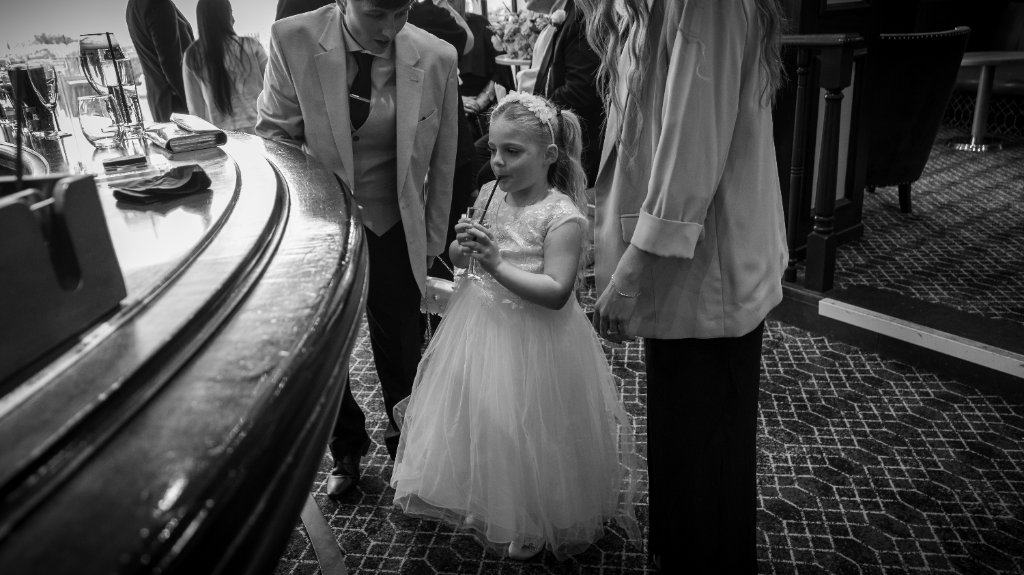 Flower girl and guests at a bar counter