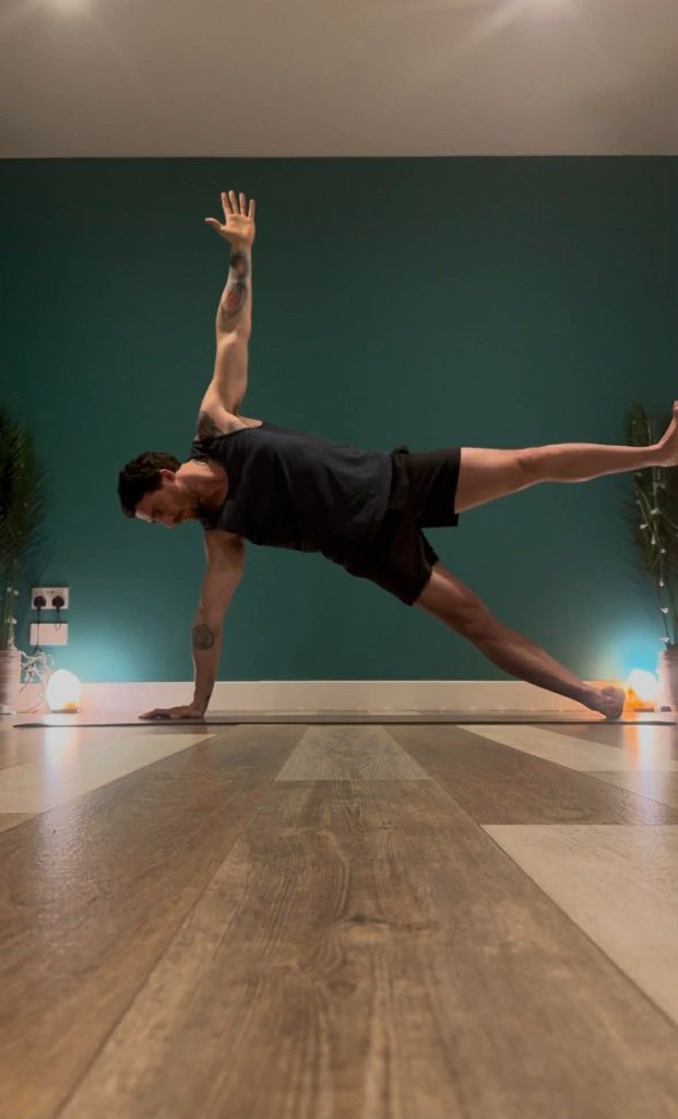 Yoga instructor Max Walsh teaching a flexibility-focused class