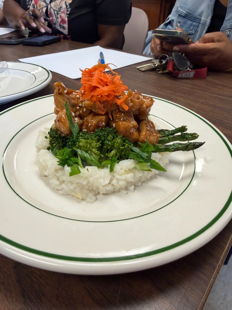 Plated chicken, broccoli, and rice