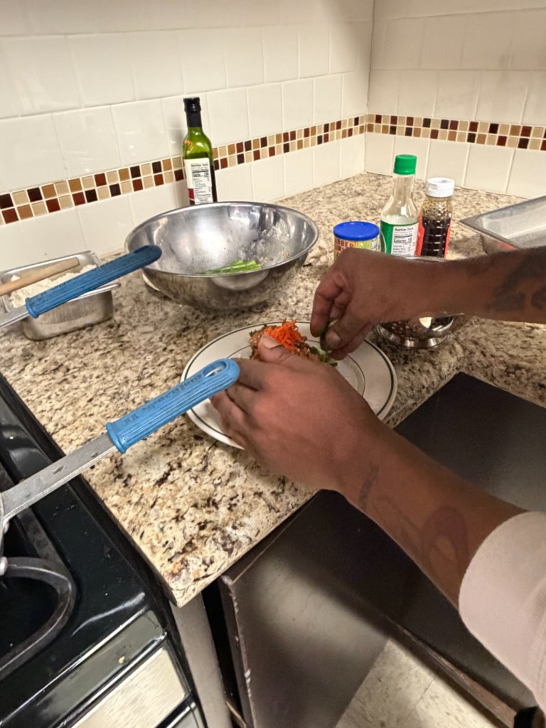 Plating a dish with garnish in the kitchen