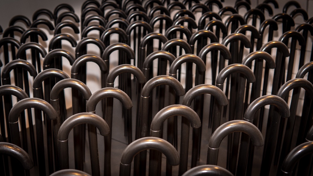 Detail — hand-carved dates on wooden canes, measuring the passage of a year through touch and time.