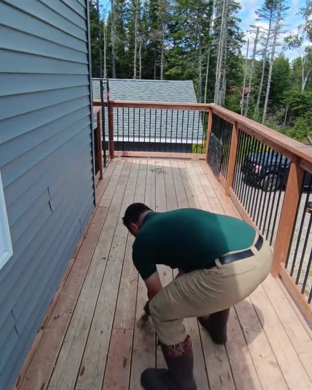 Clearing and washing down a back deck on a Lake Lane service visit