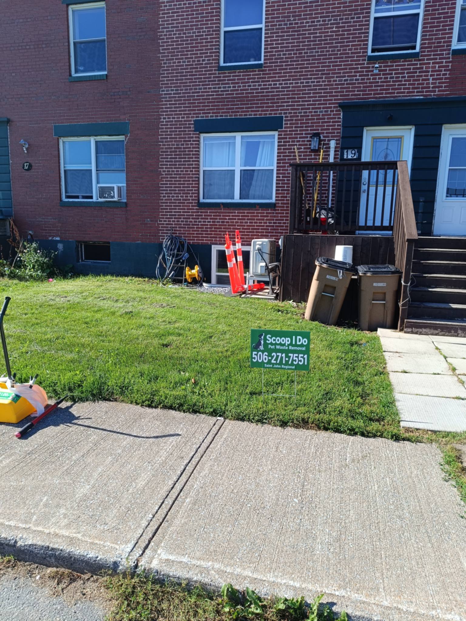 A Scoop I Do yard sign on a front lawn in Saint John