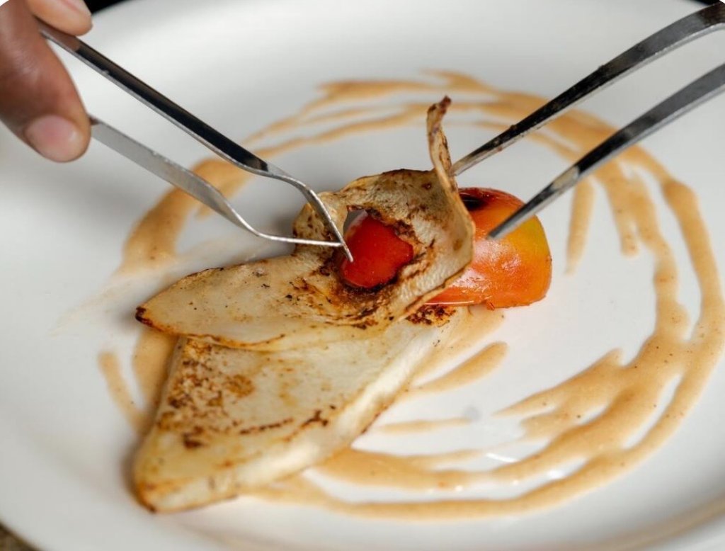 Tweezer plating a roasted tomato