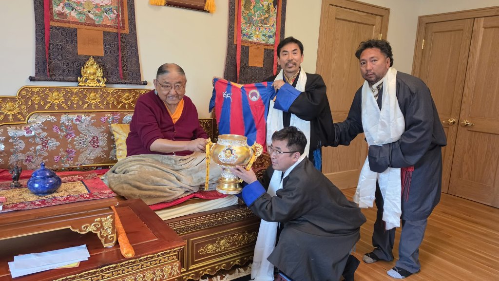TNSA team presenting jersey and trophy