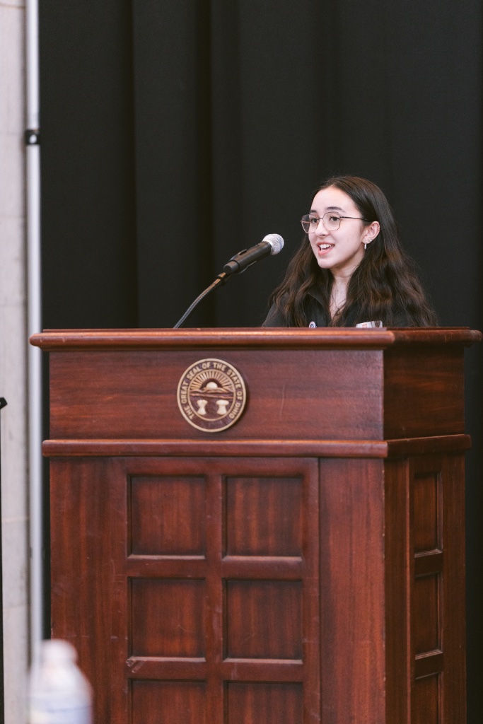 Young woman speaking at the podium
