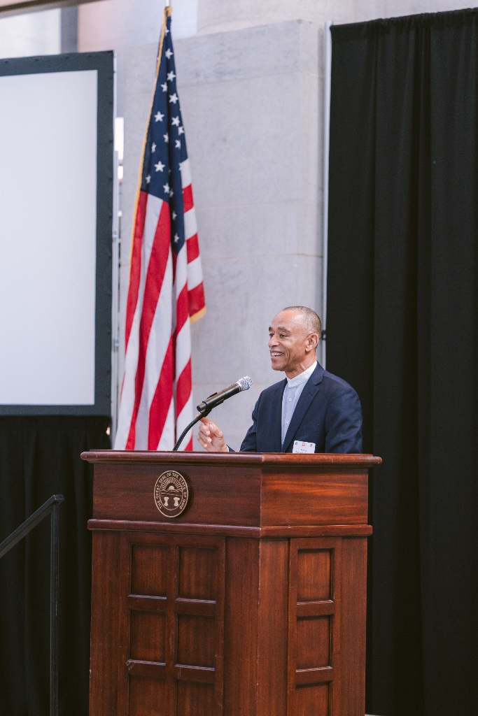Speaker at the podium with American flag