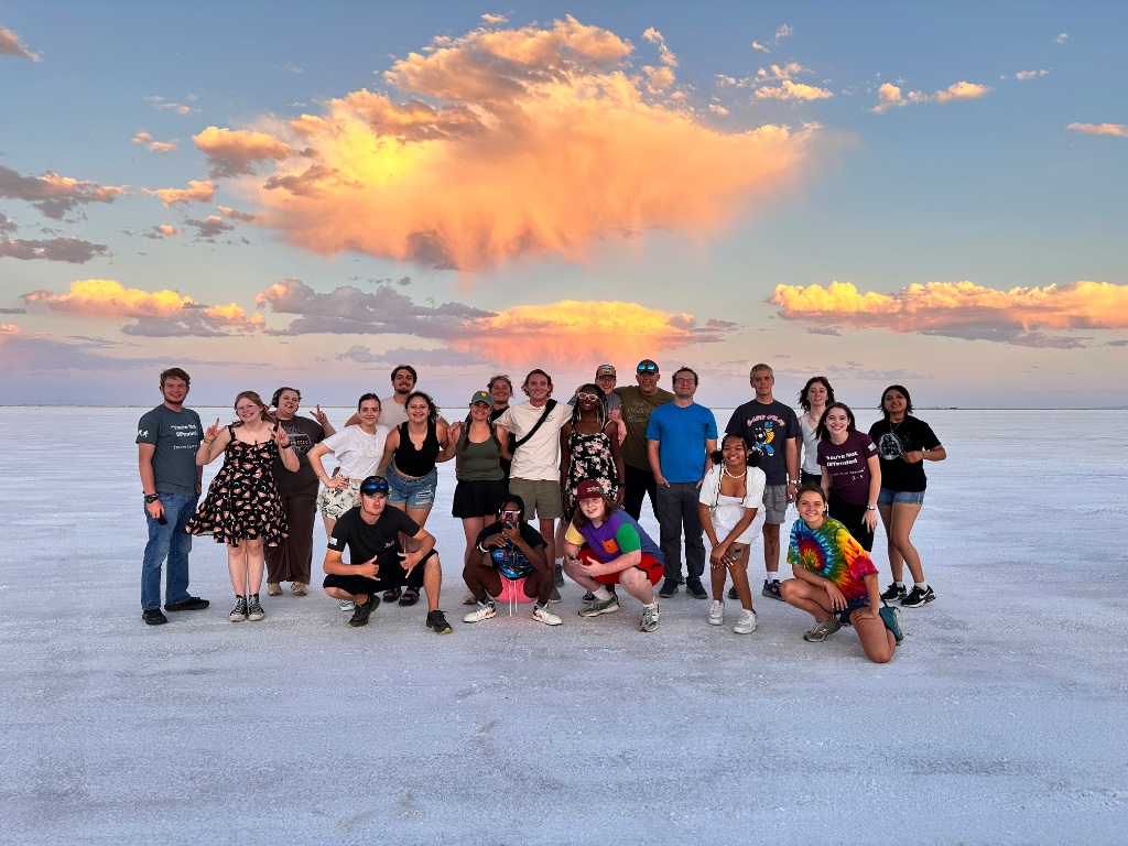 Mountain Heights Academy graduates with American Exchange Project guests at the Salt Flats