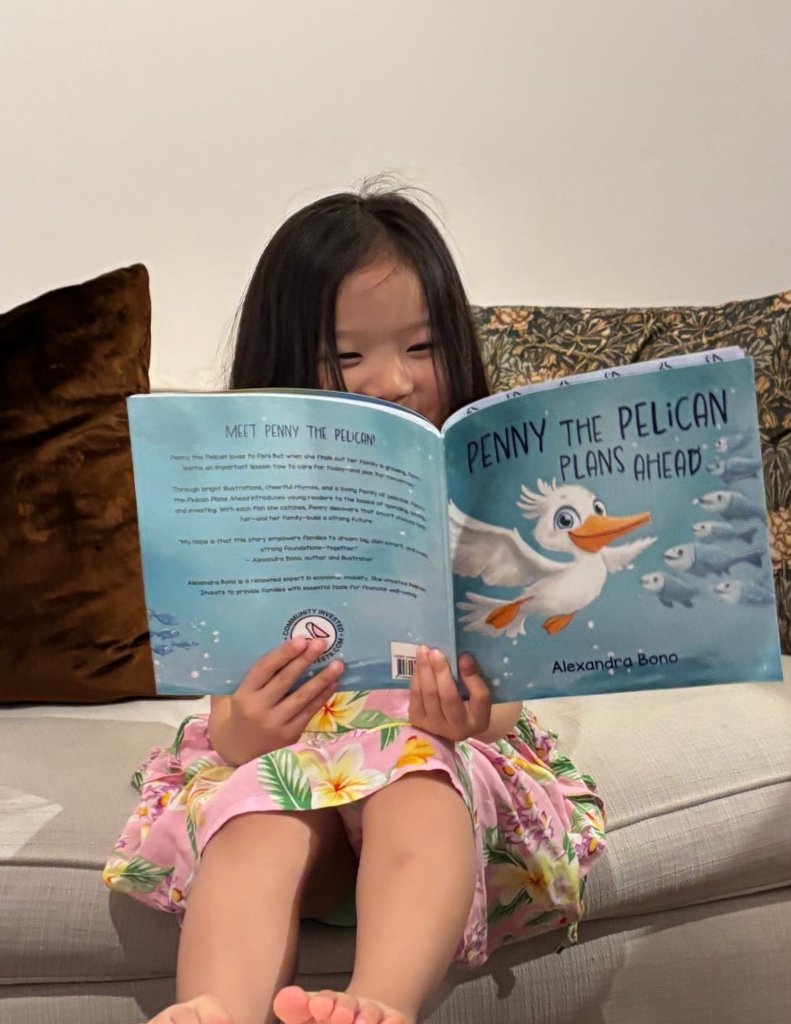 Young girl reading Penny the Pelican Plans Ahead on the couch