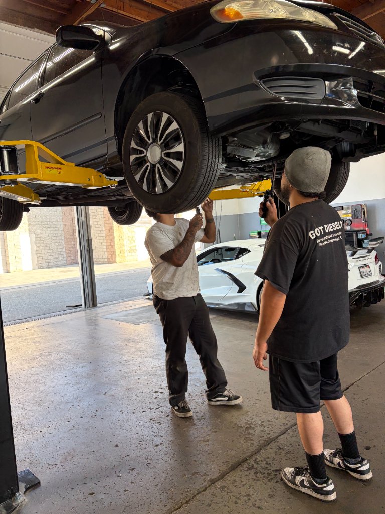 Mechanic servicing a vehicle in the shop