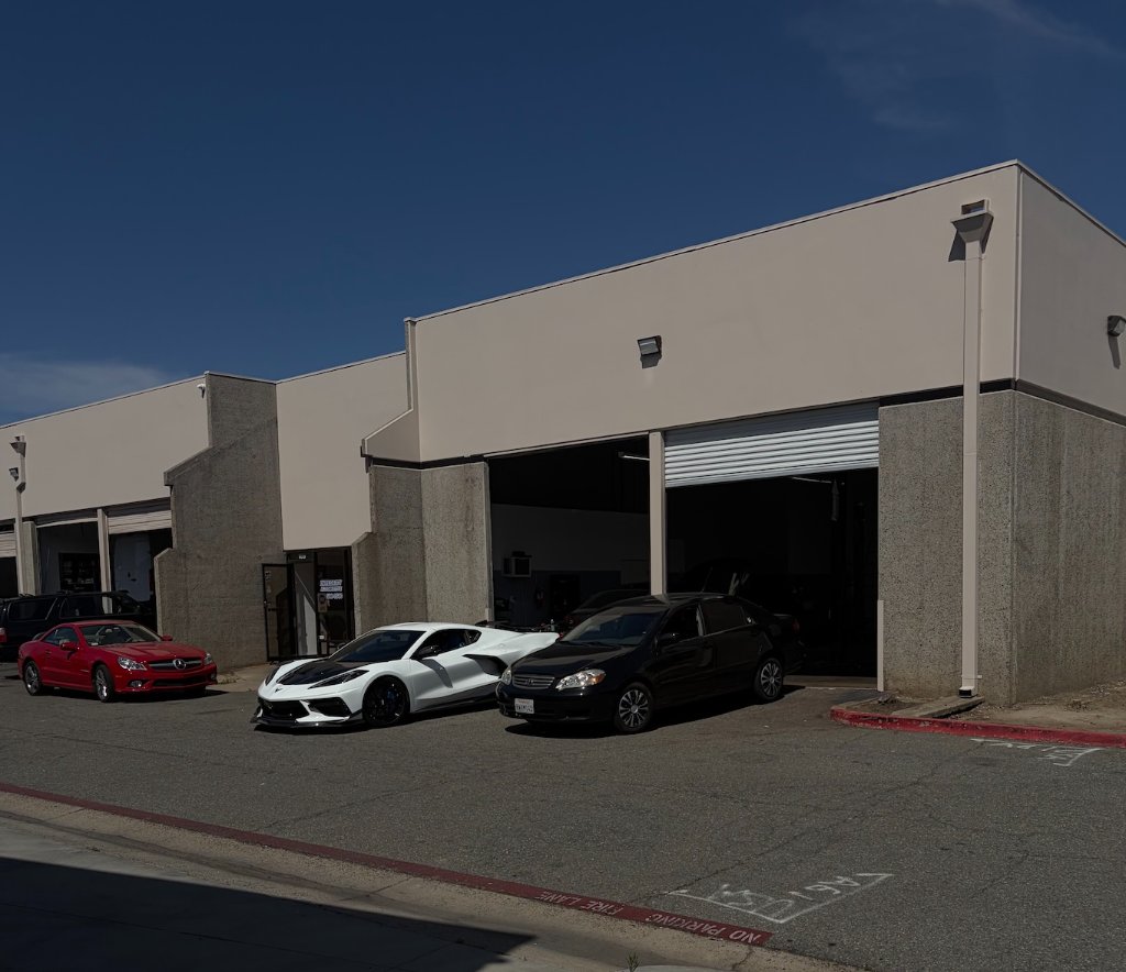 Shop exterior with customer vehicles
