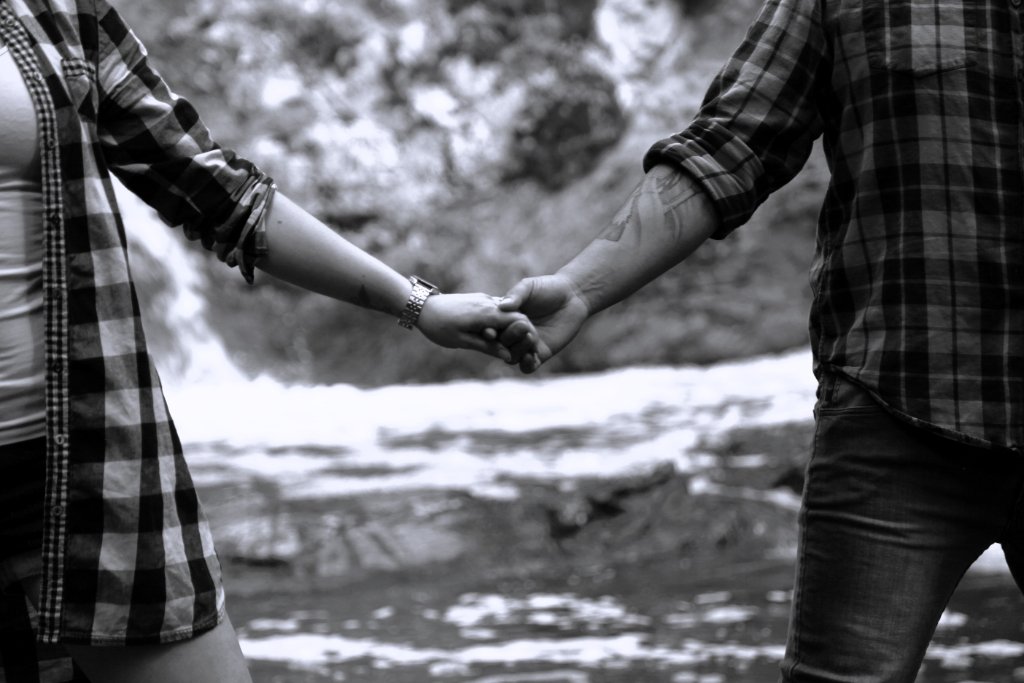 Couple holding hands black and white photography