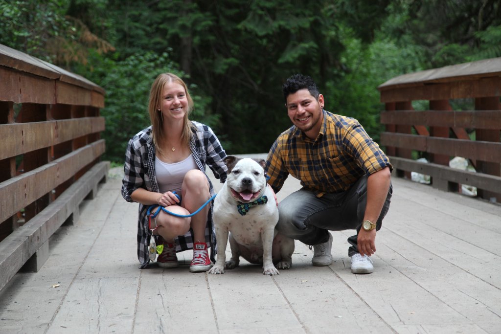 Couple with dog on bridge engagement photo