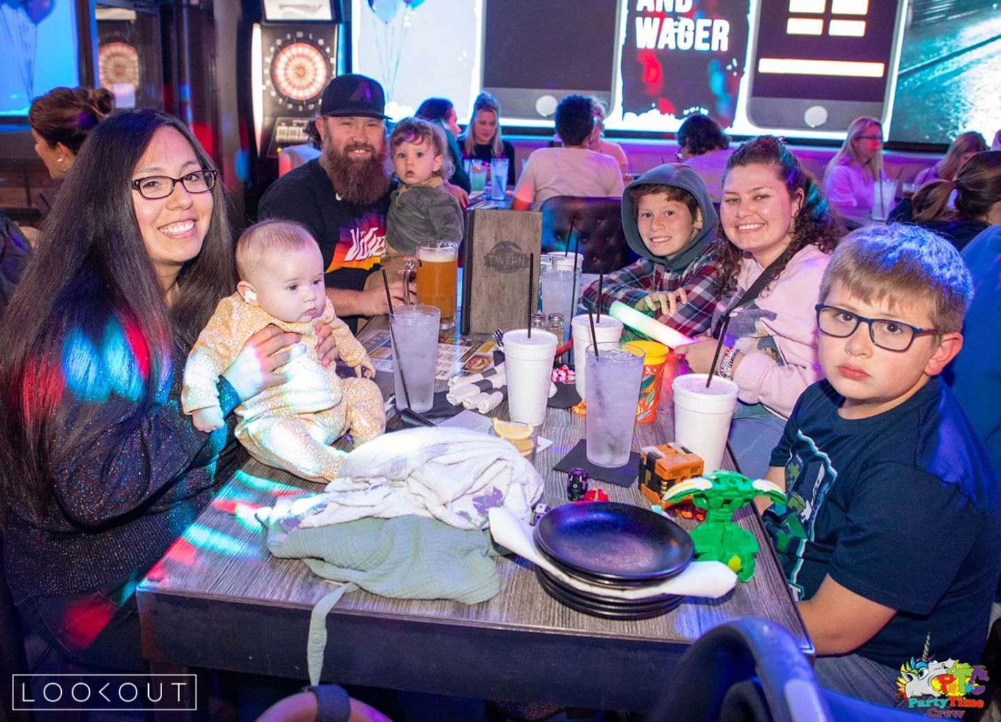 Families with kids at a table on Monday family trivia