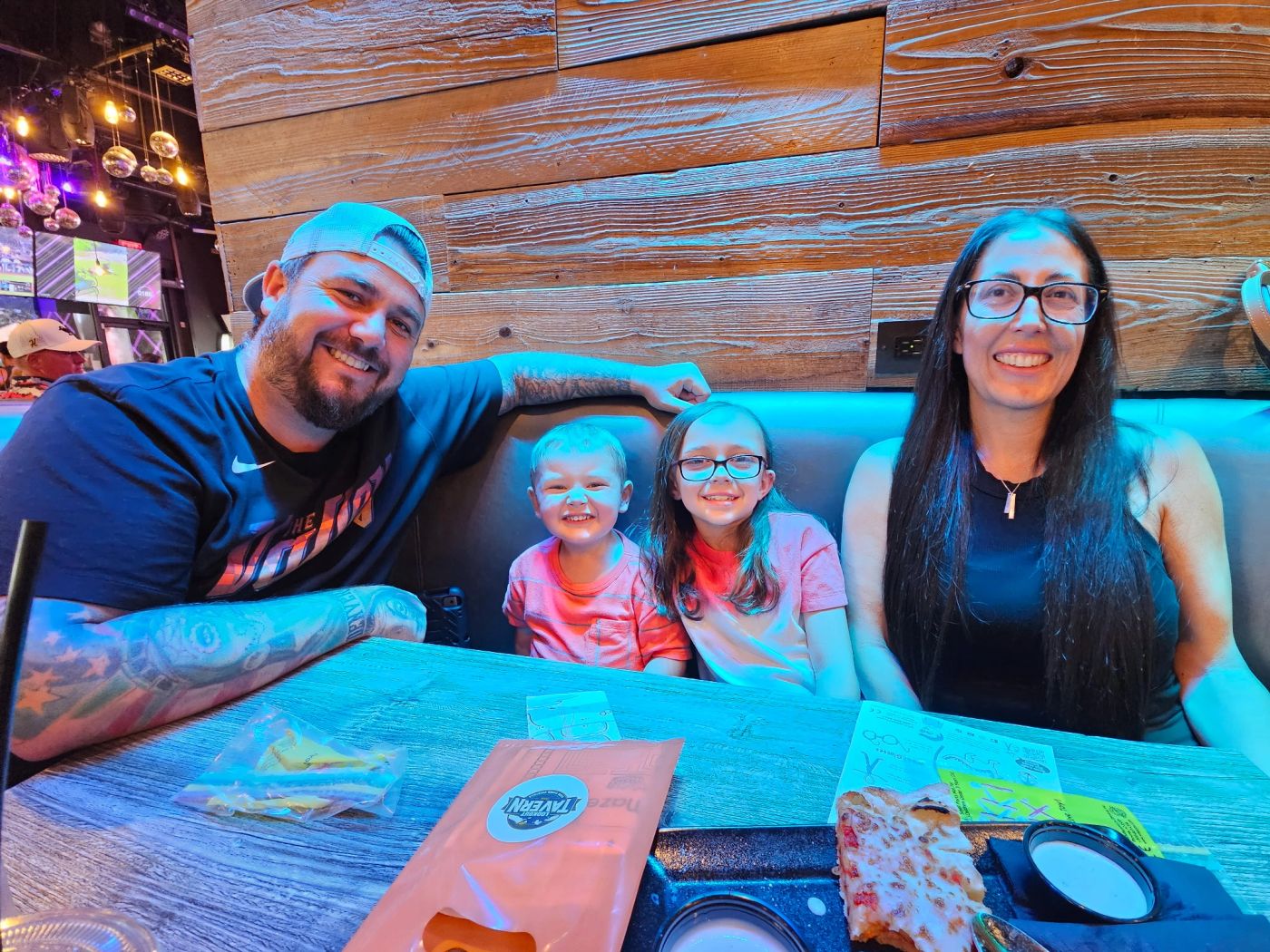 A family in a booth on family trivia night