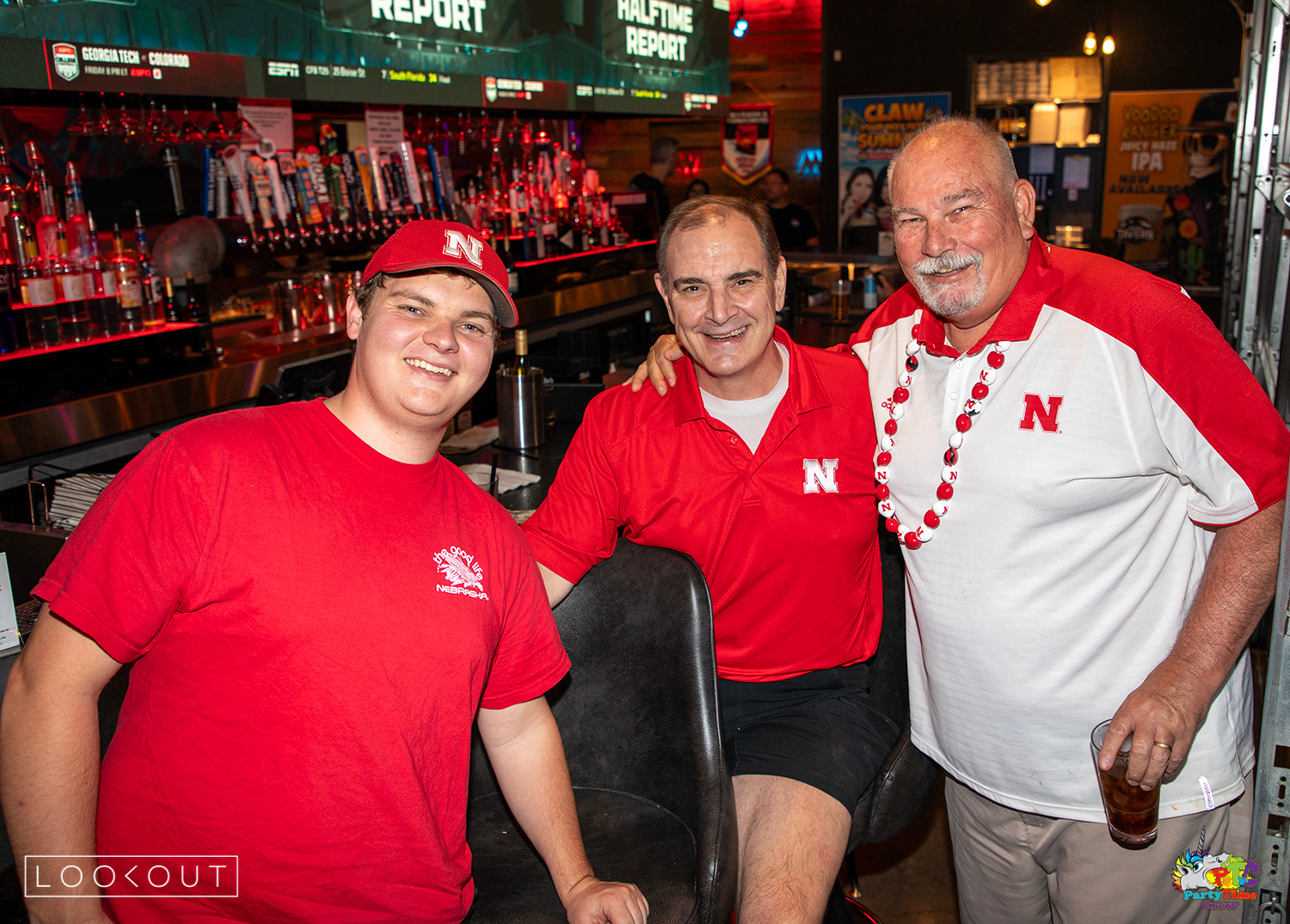 Huskers fans at the bar with the halftime report on the LED wall