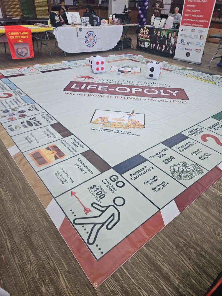 Full view of the WBL Life-Opoly floor board game laid out at an event
