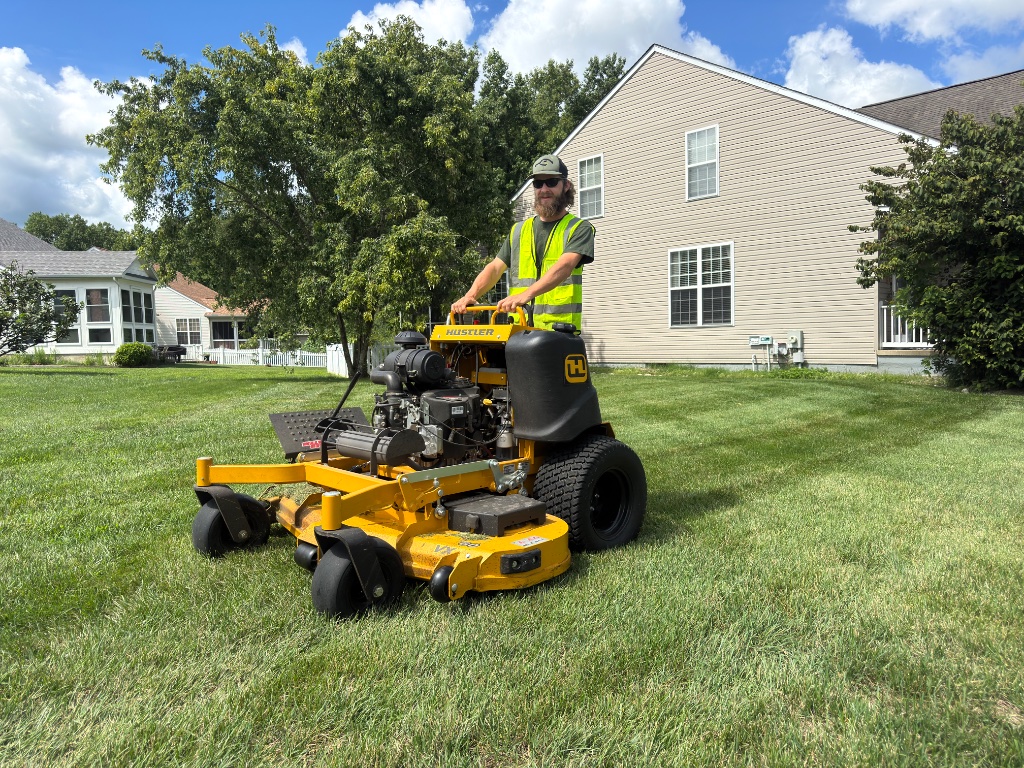 Sommerscapes team member operating a Hustler commercial mower