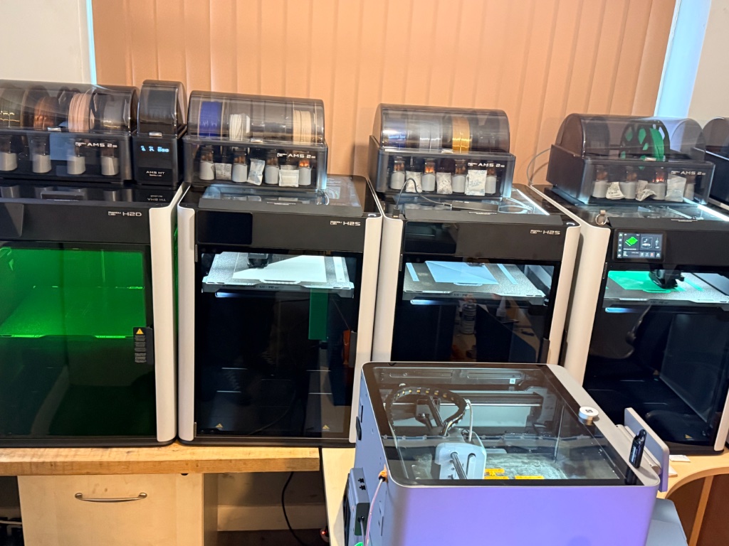 Our printer farm — multiple Bambu Lab machines running simultaneously