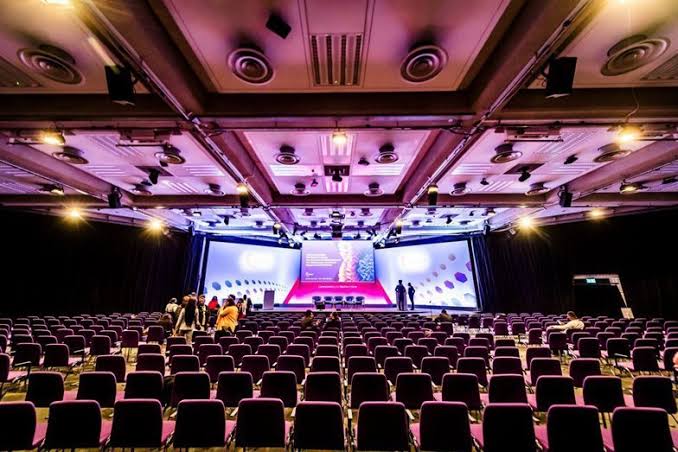 Conference hall interior with purple seating and main stage
