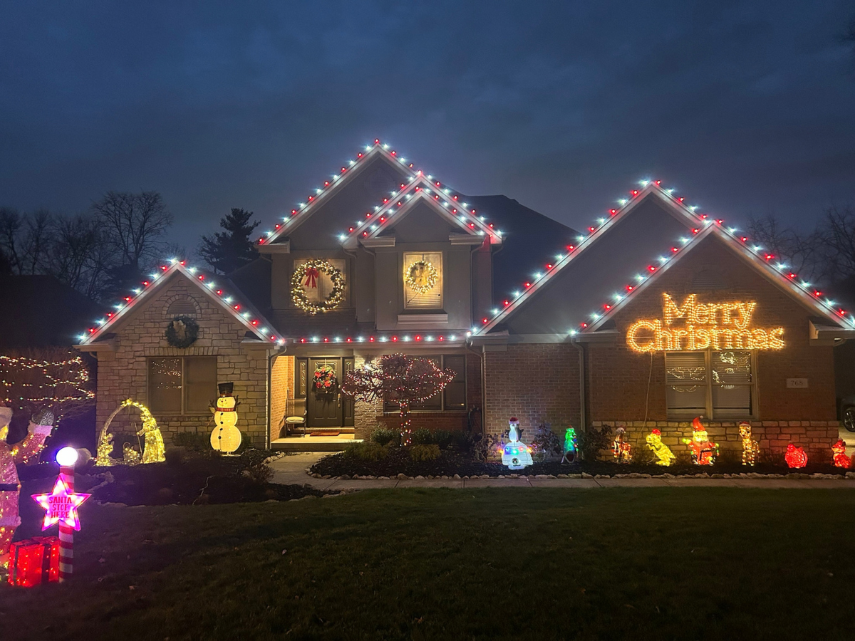 Colorful Christmas light display with Merry Christmas sign