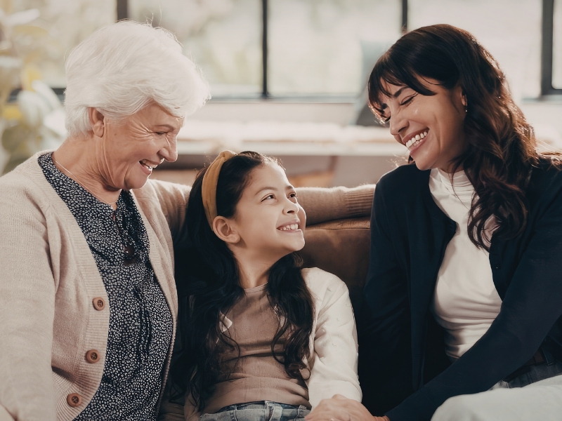 Three generations of women smiling together