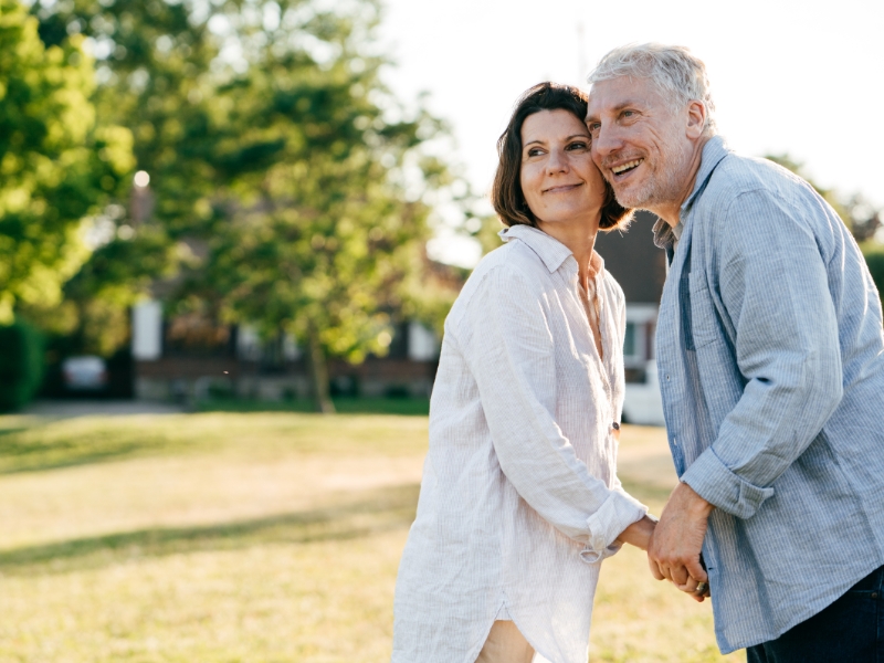 Happy couple outdoors planning for retirement