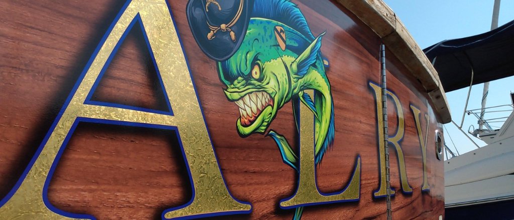 Custom gold transom artwork on woodgrain wrap