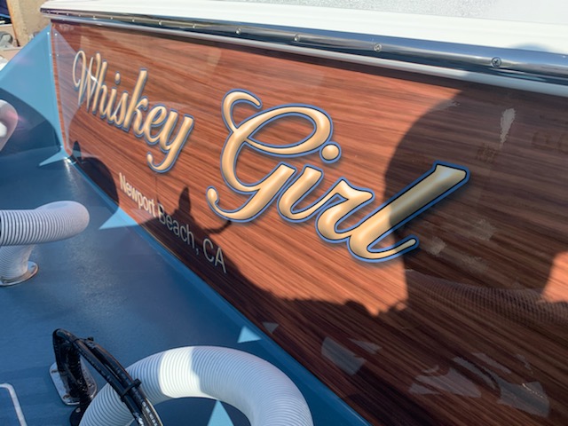 Whiskey Girl transom graphic with woodgrain finish