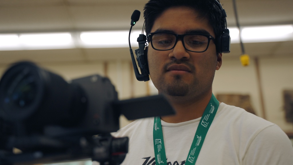 Student with audio equipment
