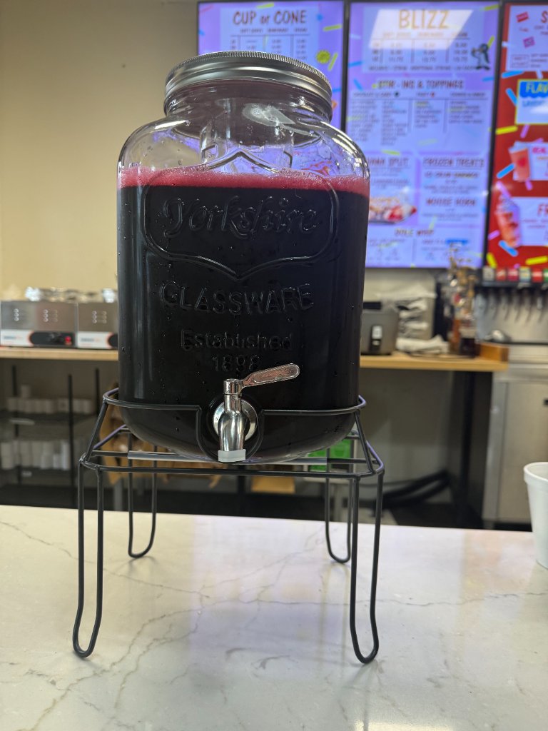 Jamaica agua fresca in a glass dispenser