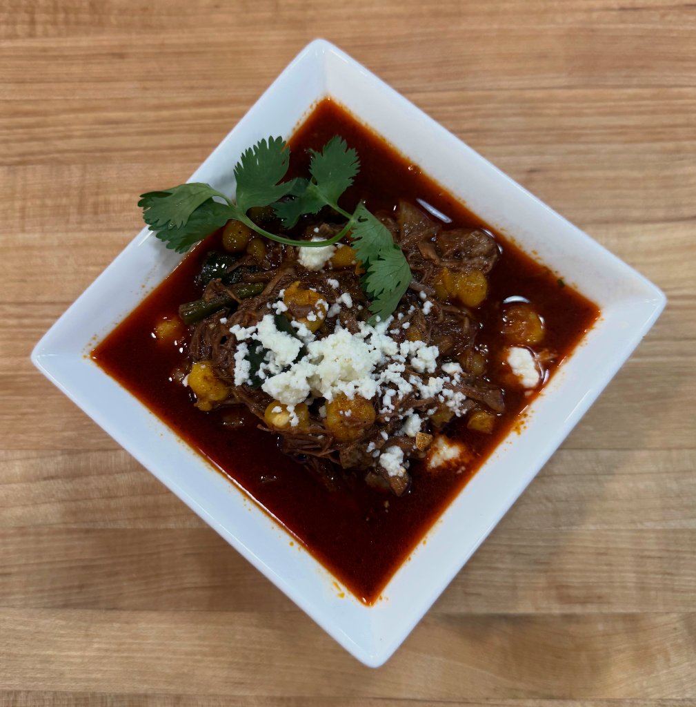 Birria in bowl with cotija on top