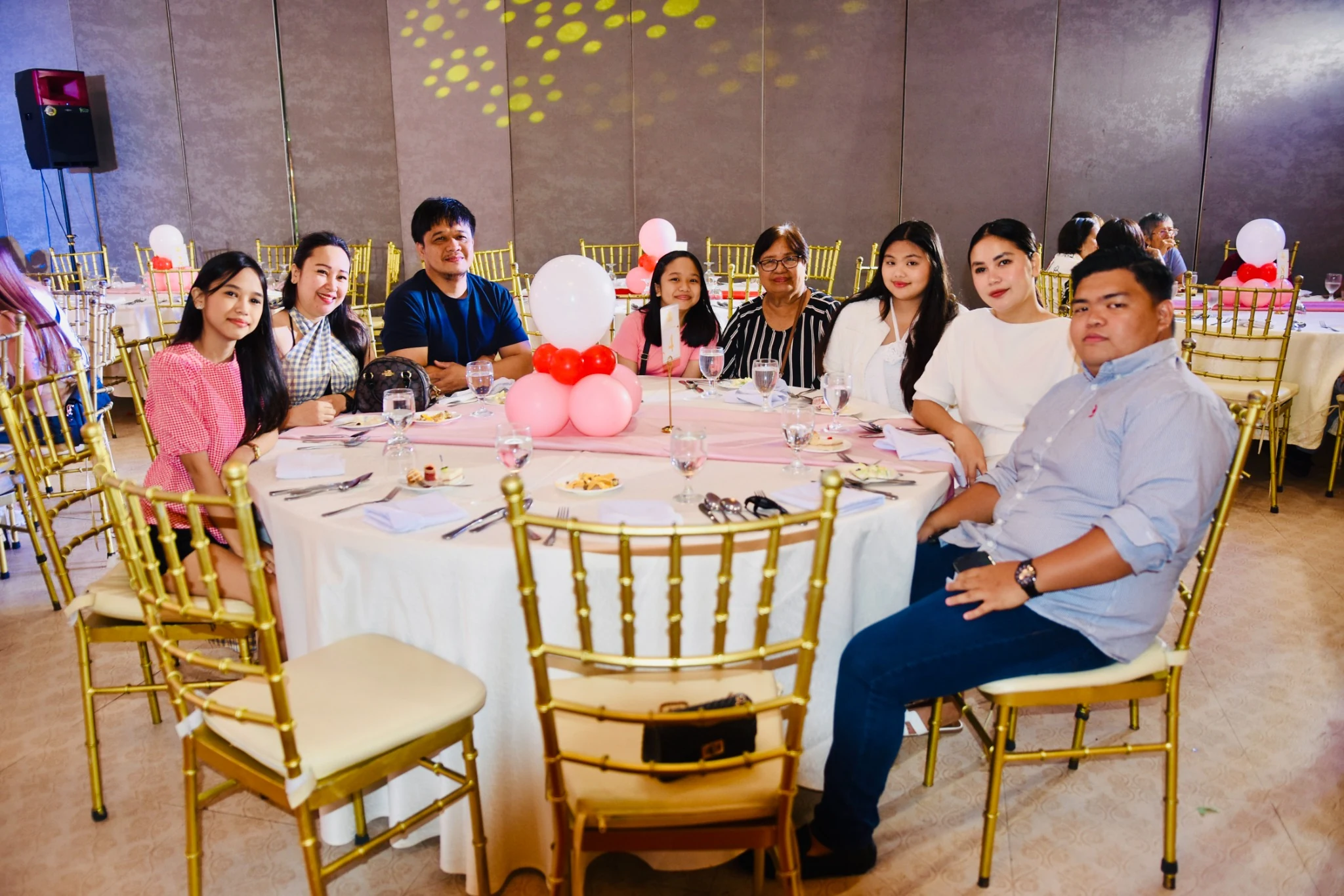 A second portrait of guests gathered at the same reception table.