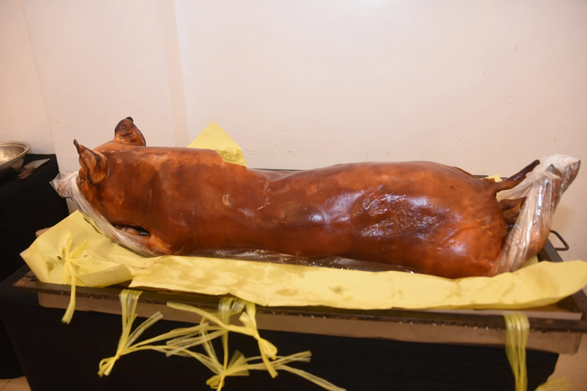 A whole roast pig prepared for the birthday celebration meal.