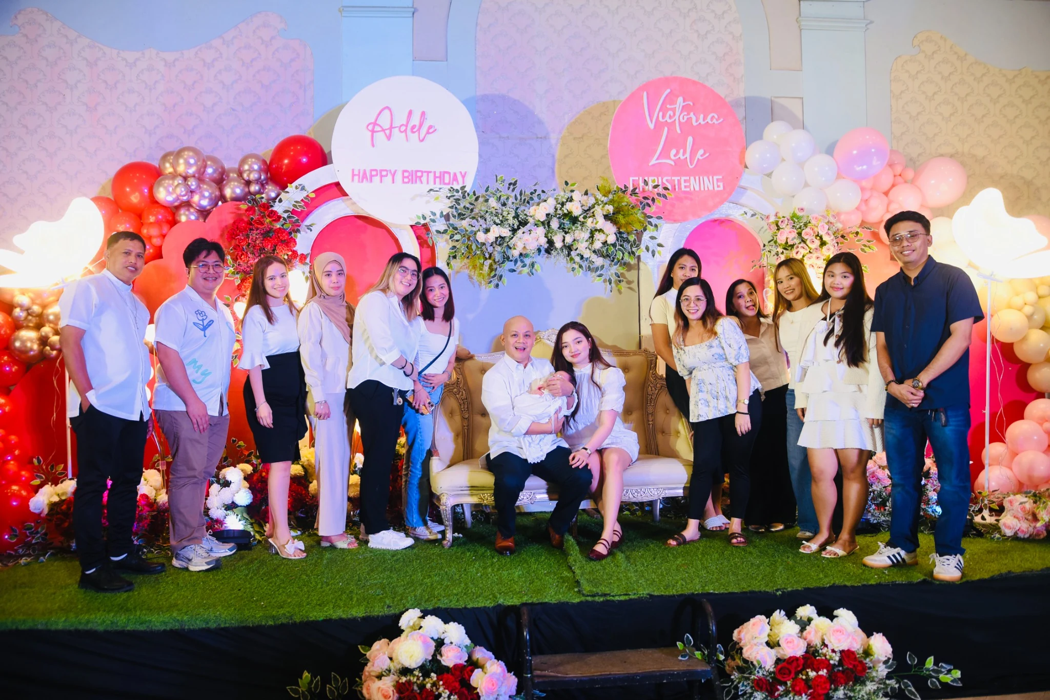Guests stand together on the reception stage for a group photograph.
