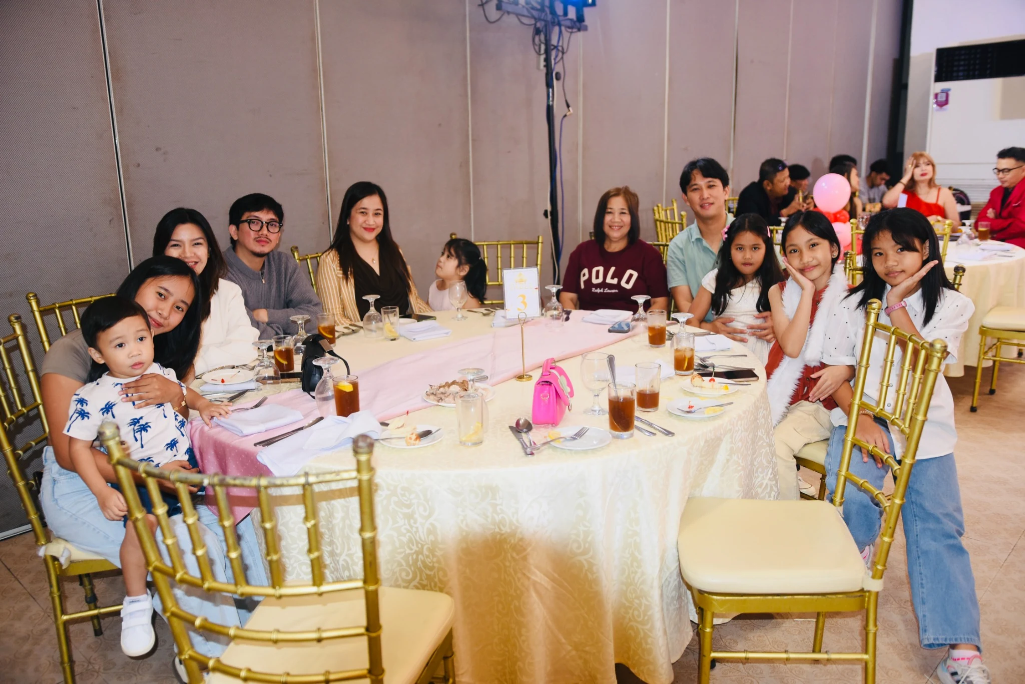 Adults and children seated together at the reception.