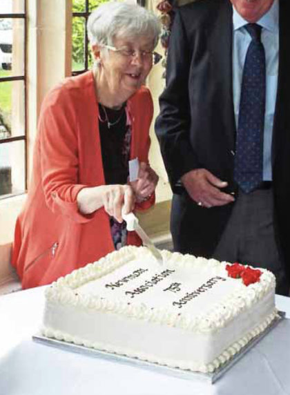 Winifred Flanagan cutting the anniversary cake